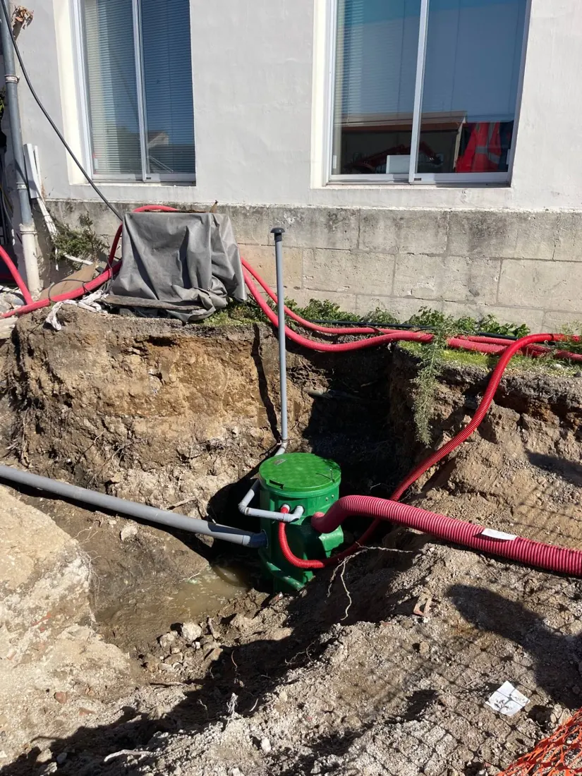 Tranchée ouverte pour réparer une fuite sur une canalisation d'eau enterrée entre le compteur et la maison